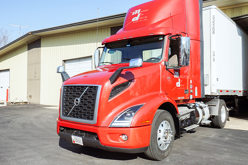 red truck leaving storage area