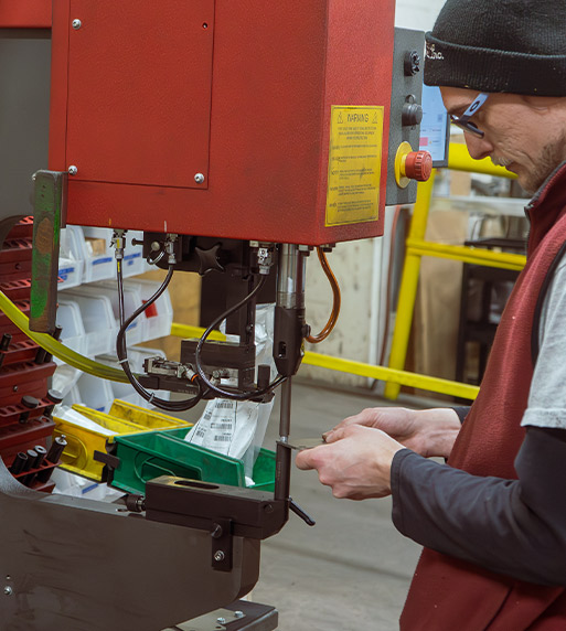 employee working stamping machinery